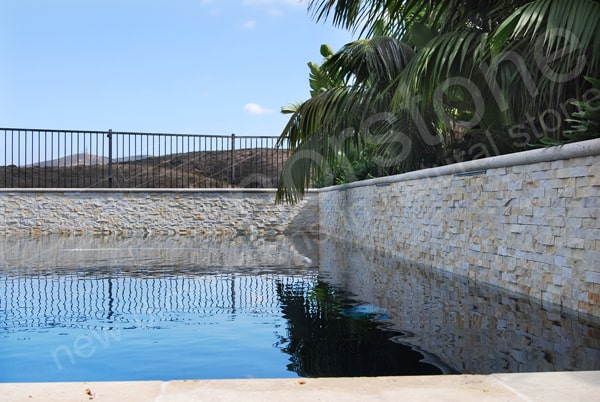 Stacked Stone Veneer used on a raised beam feature in a modern styled pool